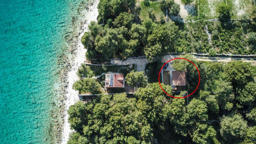 an aerial view of a house next to the ocean at Secluded fisherman's cottage Cove Duga, Ciovo - 17349 in Okrug Gornji