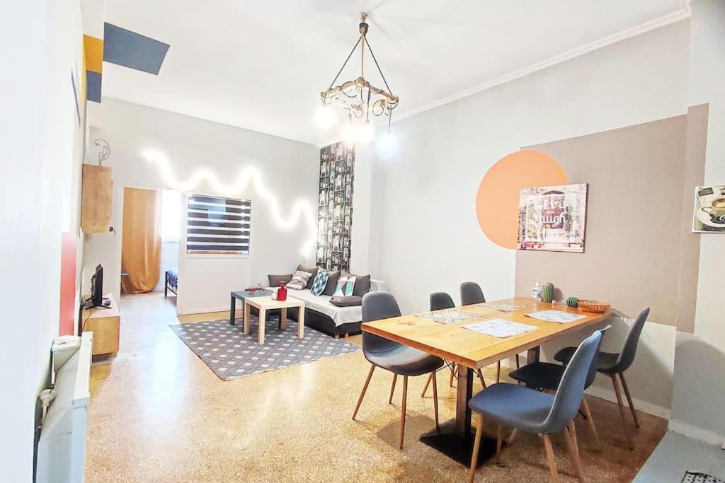 a dining room and living room with a table and chairs at AS Monastiraki Apartment 1B in Athens