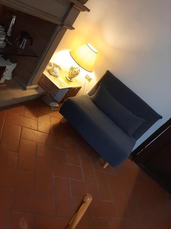 a bedroom with a bed and a table with a lamp at La Casina della Volpe in Prato