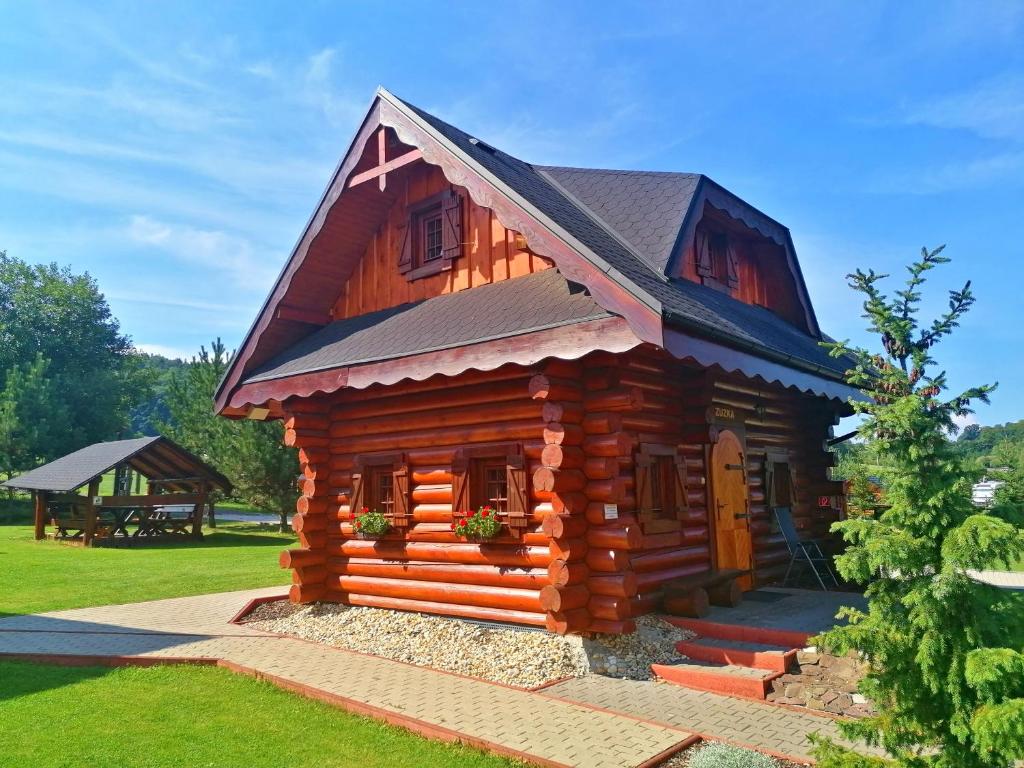a log cabin with a black roof at Ubytovanie Koliba Pacho - Zrub Zuzka in Prievidza