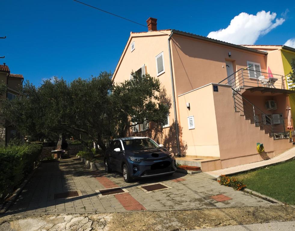 a car parked in front of a house at Apartments with a parking space Betina, Murter - 17478 in Betina