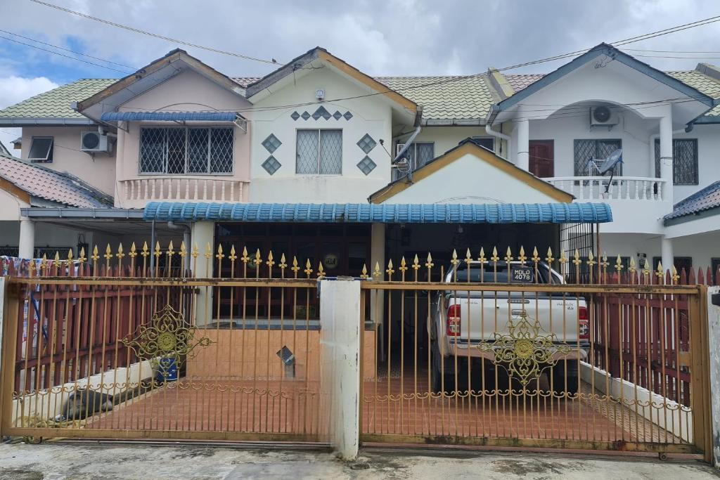 a gate in front of a house at AnNur Homestay in Lahad Datu