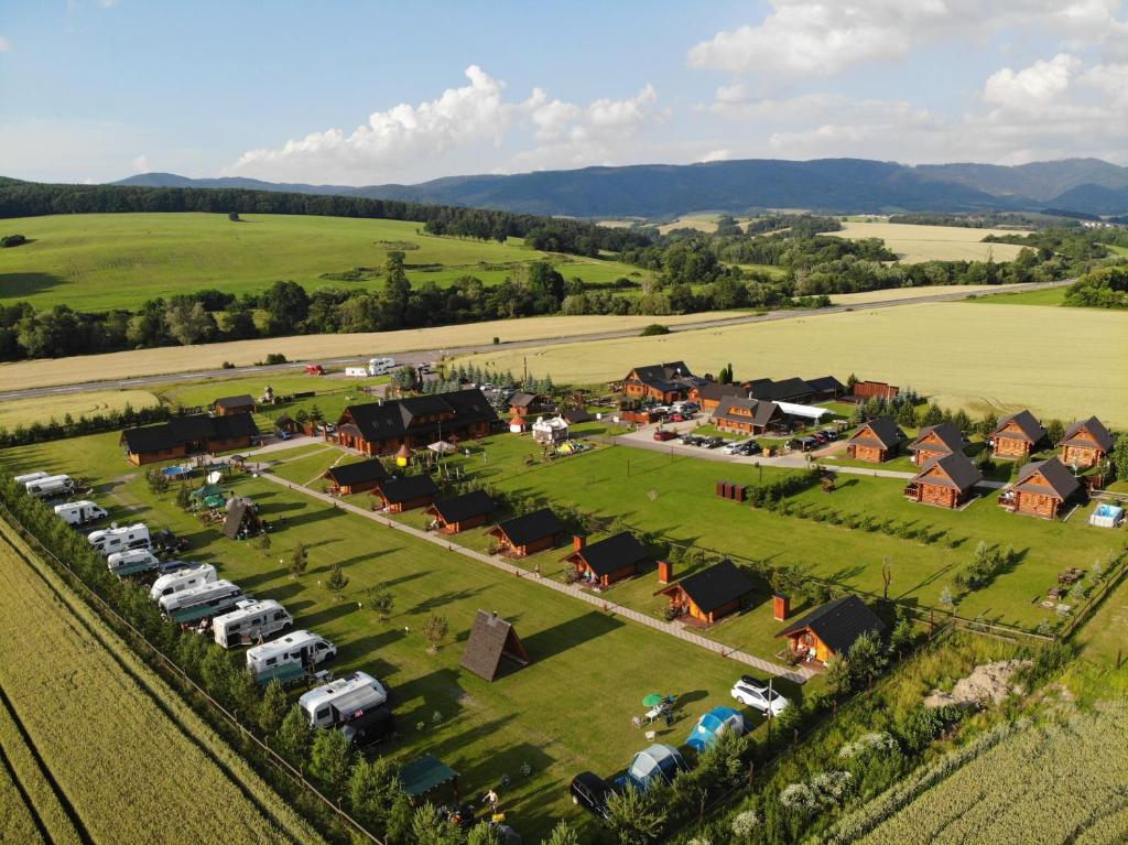 an aerial view of a village with cars parked in a field at Camp PACHO in Prievidza