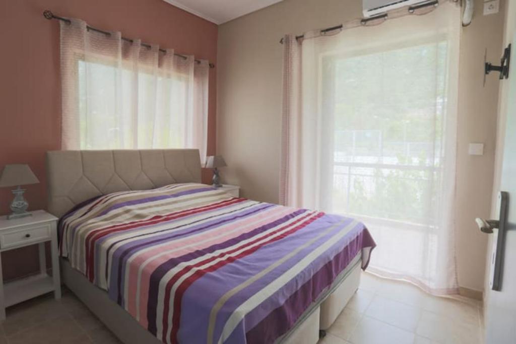 A bed or beds in a room at Vasileiou Apartments