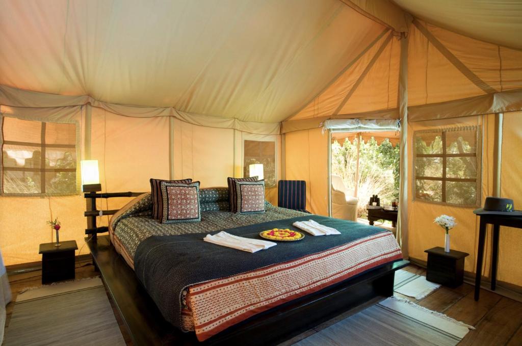 a bedroom with a bed in a tent at Khem Villas in Sawāi Mādhopur