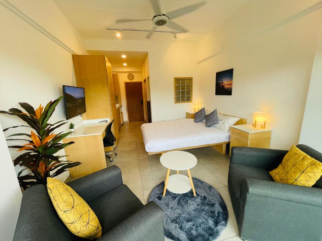 a living room with a couch and a bed at Rayong Condo Chain studio room in Ban Pak Khlong Phe