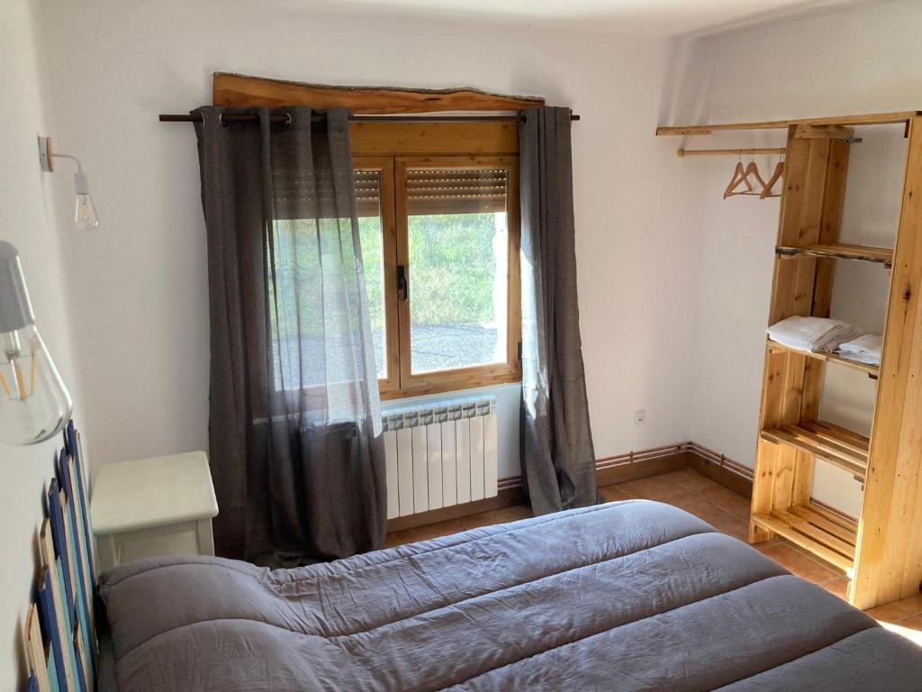 Schlafzimmer mit einem Bett und einem Fenster in der Unterkunft Casas Rurales La Trufa Madre Casa 2 in Vega del Cadorno