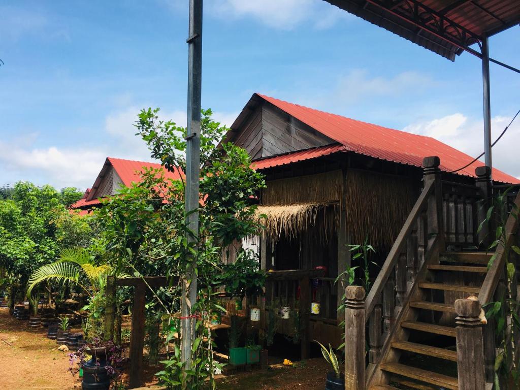 a house with a staircase leading up to it at Ratanakiri Farmhouse & Trekking in Banlung