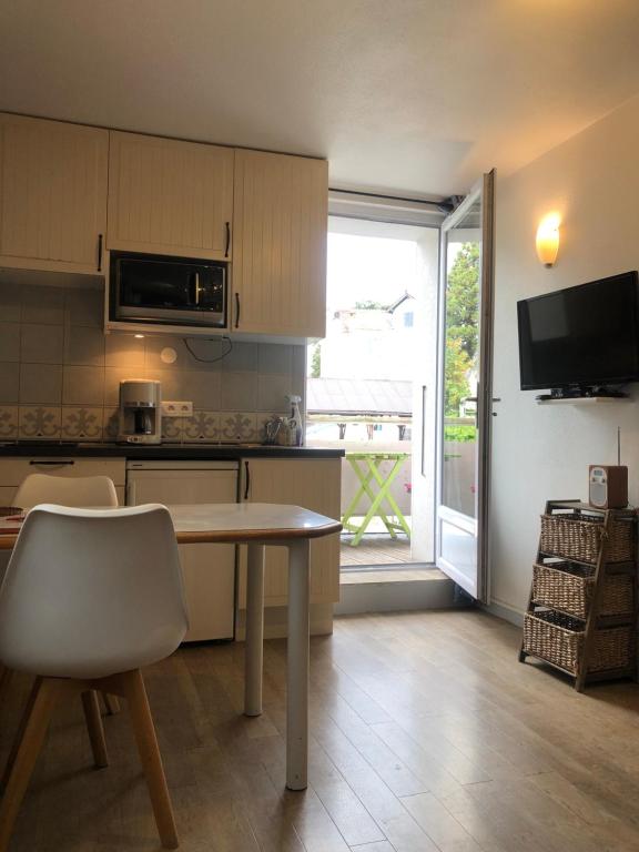 a kitchen with a table and a large window at studio 6 Versoie avec parking in Thonon-les-Bains