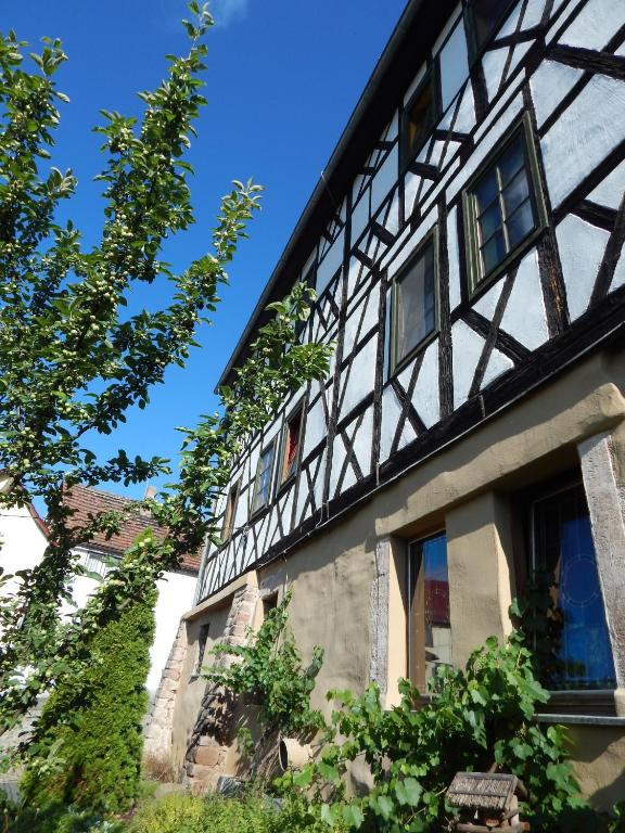 a building with a black and white building at Landhotel Edelhof in Uhlstädt