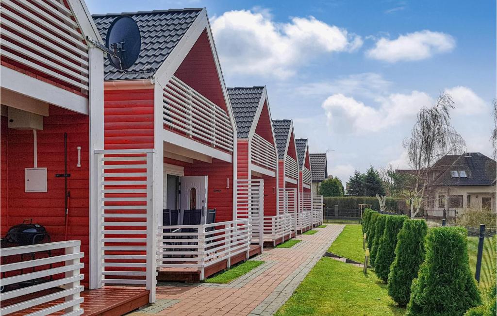 a row of red and white houses on a street at 2 Bedroom Gorgeous Home In Sianozety in Sianozety