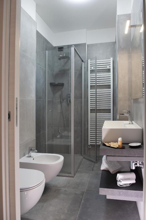 a bathroom with a shower and a sink and a toilet at B&B Lough in Colà di Lazise