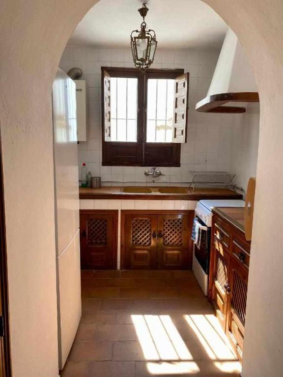 kuchnia z oknem, zlewem i kuchenką w obiekcie La Casona de la Sierra w mieście Higuera de la Sierra
