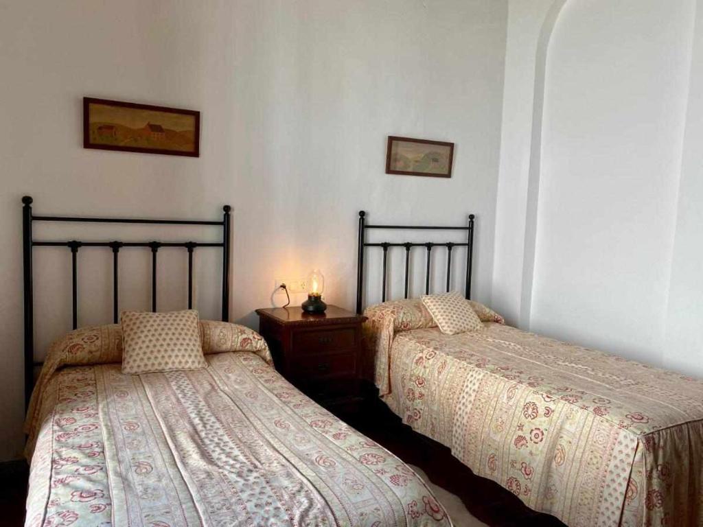 Łóżko lub łóżka w pokoju w obiekcie La Casona de la Sierra
