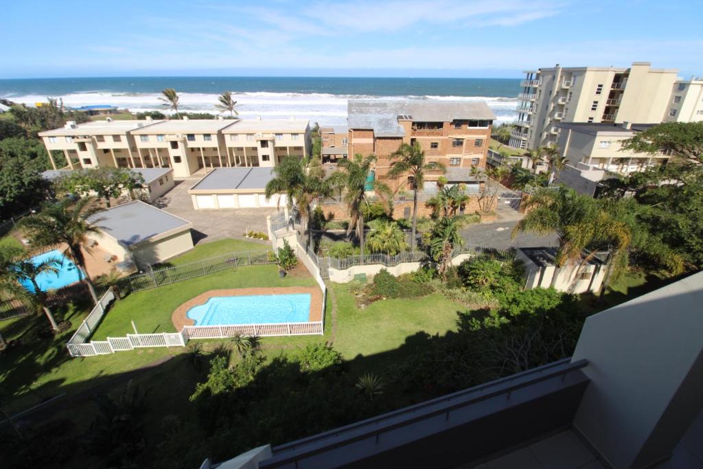 an aerial view of a resort with a swimming pool and the ocean at Mont Blanc 17 in Margate