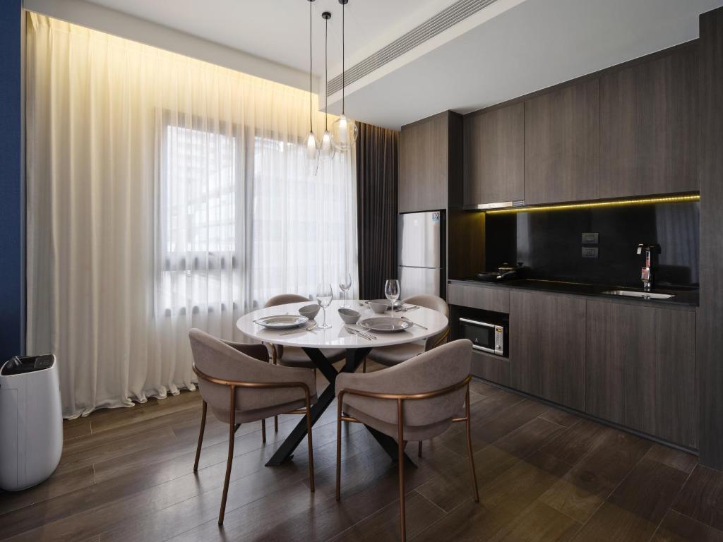 A compact dining kitchen with a round table set for four.