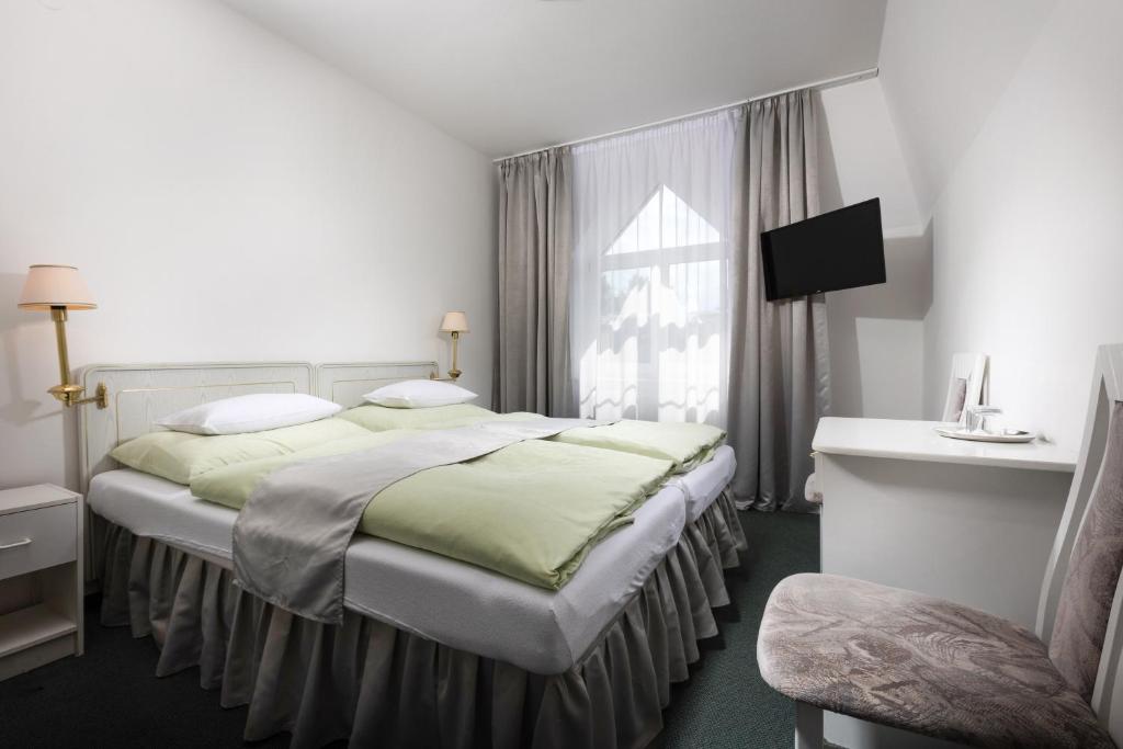Łóżko lub łóżka w pokoju w obiekcie Hotel Ferdinand