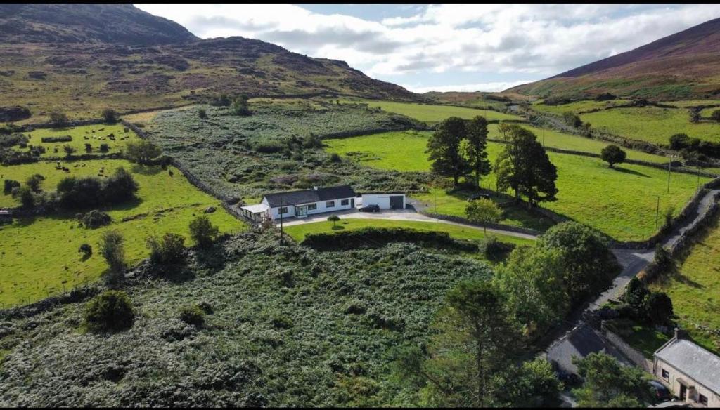 an aerial view of a house in a green field at Mountain House Omeath near Carlingford in Ó Méith