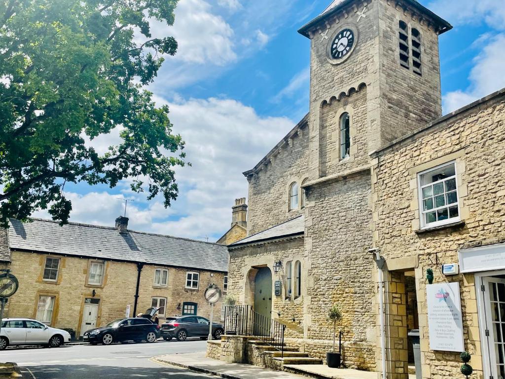 an old stone building with a clock tower at The Clock Tower Stow in Stow on the Wold