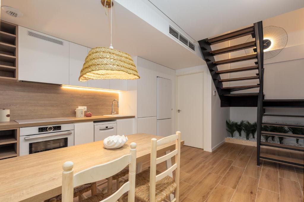 a kitchen and dining room with a wooden table at ApartUP Opera Loft Love in Valencia