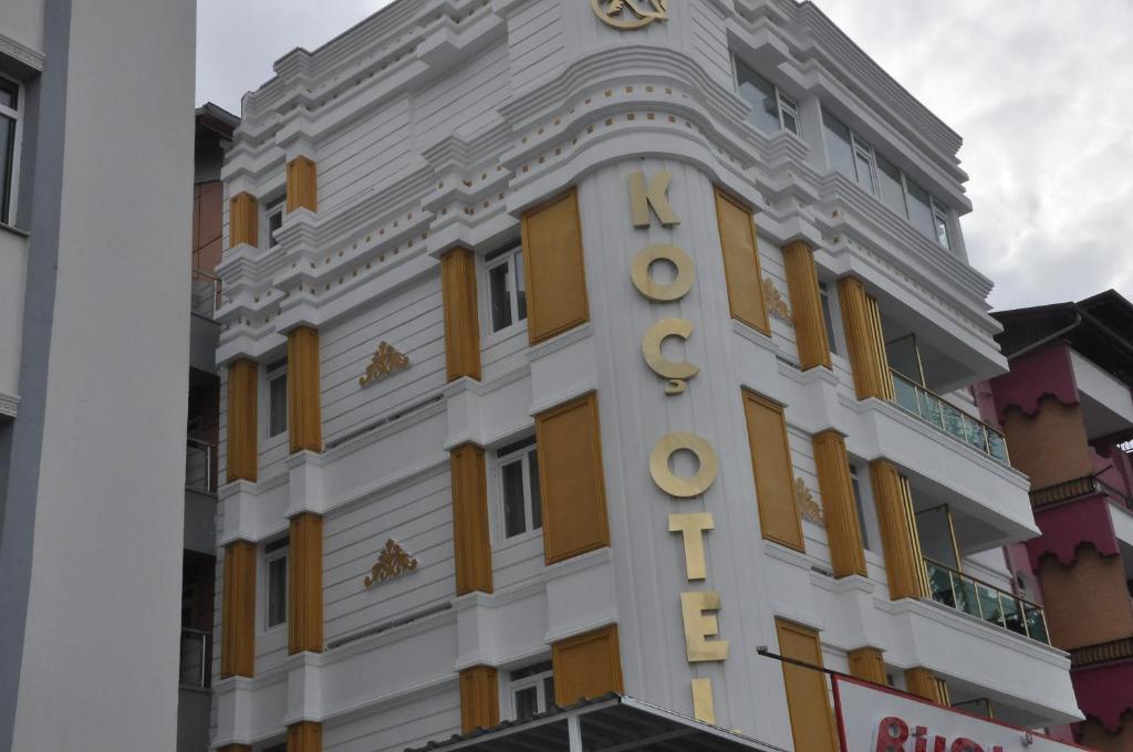 a building with a clock on the side of it at KOÇ OTEL ELİT TERMİNAL in Isparta