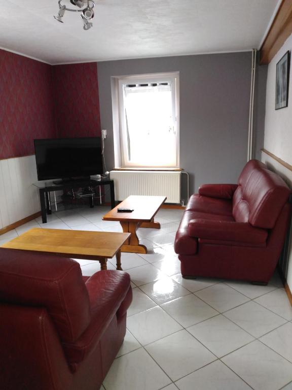 a living room with two couches and a table at gite chez Maise in Le Val-dʼAjol