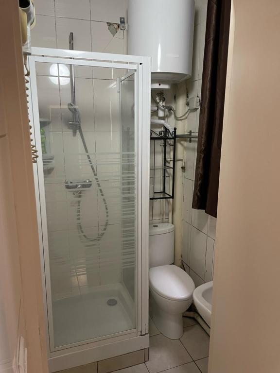 a bathroom with a toilet and a glass shower at RENT APPART - Colombes in Colombes