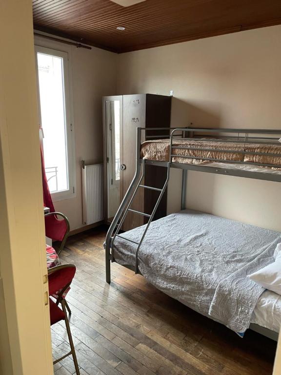 a room with two bunk beds and a chair at RENT APPART - Colombes in Colombes