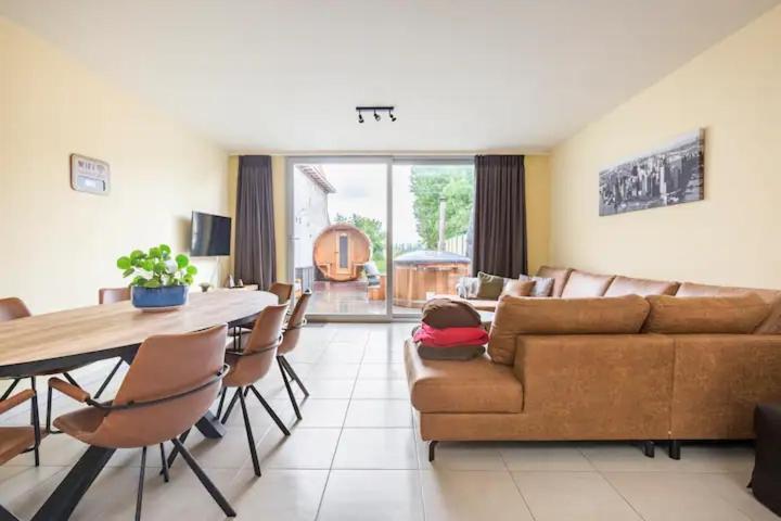 a living room with a couch and a table at L'eau de vie in Alveringem