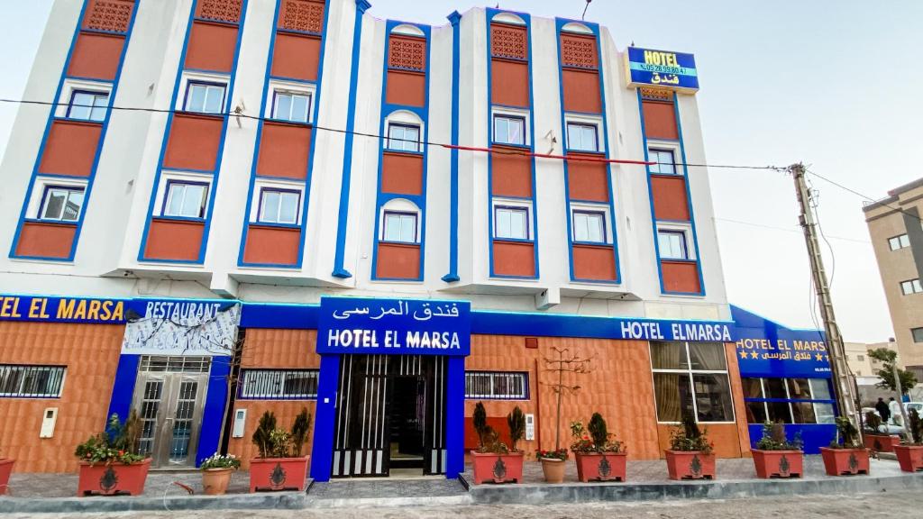 a large building with blue and red at Hotel EL MARSA LA PLAYA in Laayoune