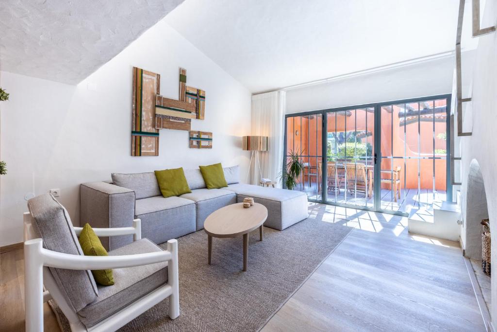 een woonkamer met een bank en een tafel bij Onyria Quinta da Marinha Villas in Cascais