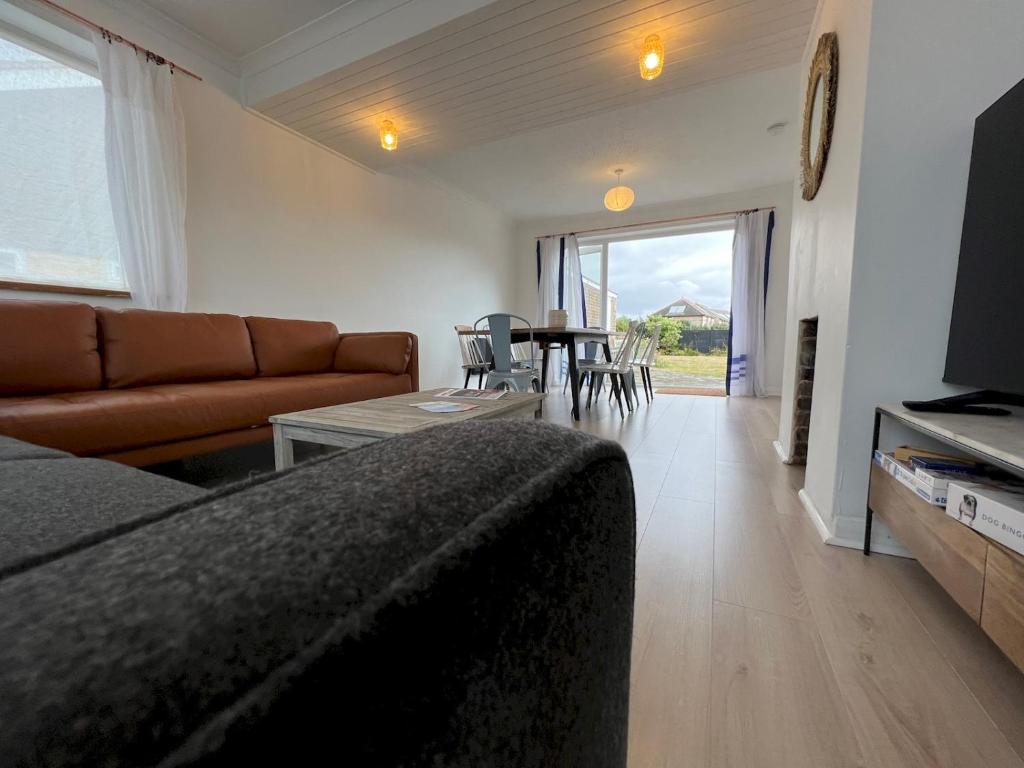 a living room with a couch and a table at Pass the Keys The Sands Superb Newly Refurbished Beach Home in Rye