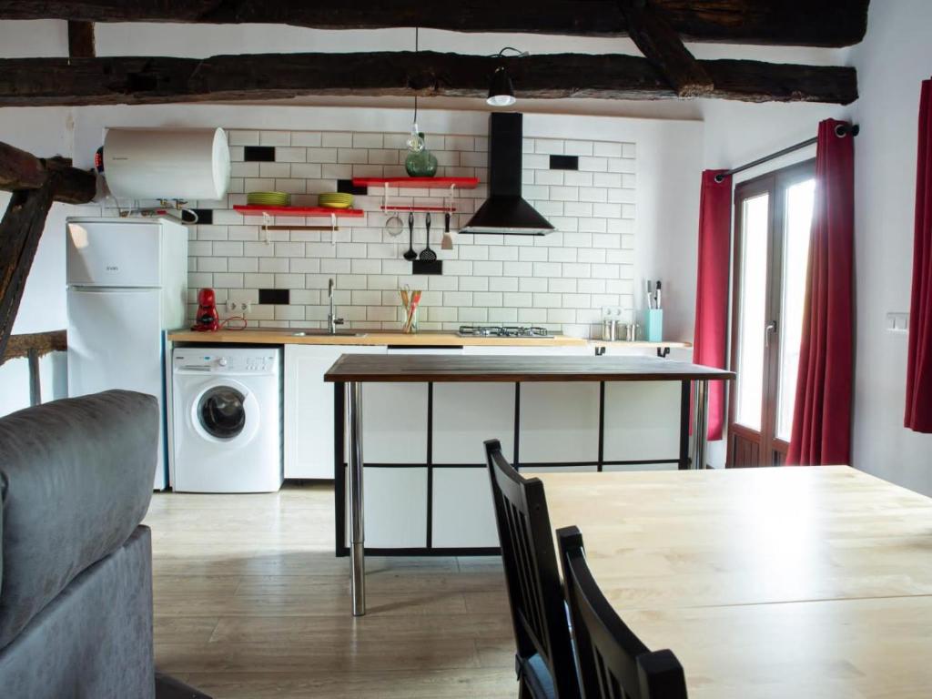 a kitchen with a table and a counter top at Okana Baserria in Muxika