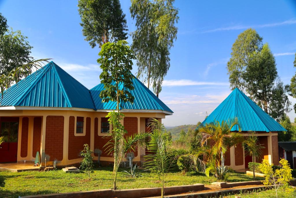 a house with a blue roof at Sina Village in Mpigi