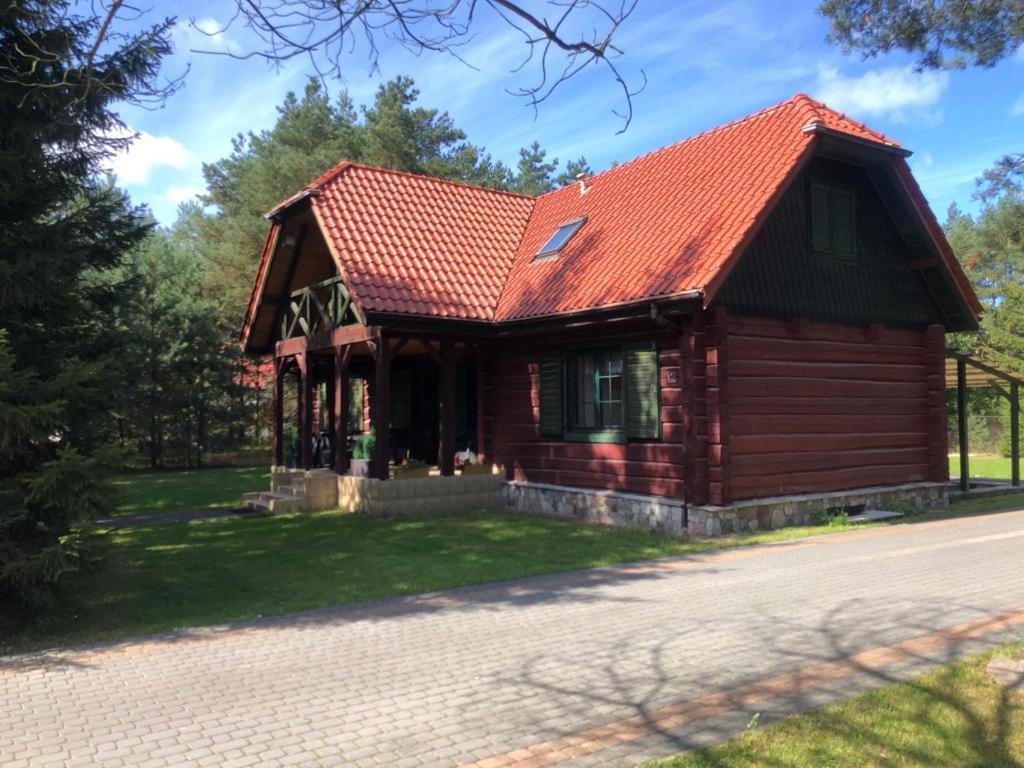 a small wooden house with a red roof at House NORDA in Jastrzębia Góra