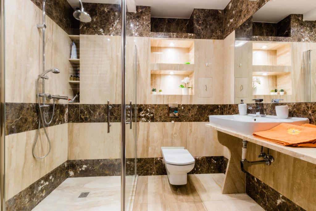 La salle de bains est pourvue d'une douche, de toilettes et d'un lavabo. dans l'établissement Belweder Diamentowy, à Olsztyn