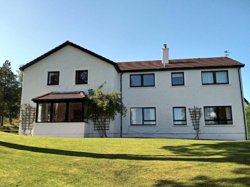 a large white house with a large yard at Lochs Lodge, Glenlyon, Perthshire 