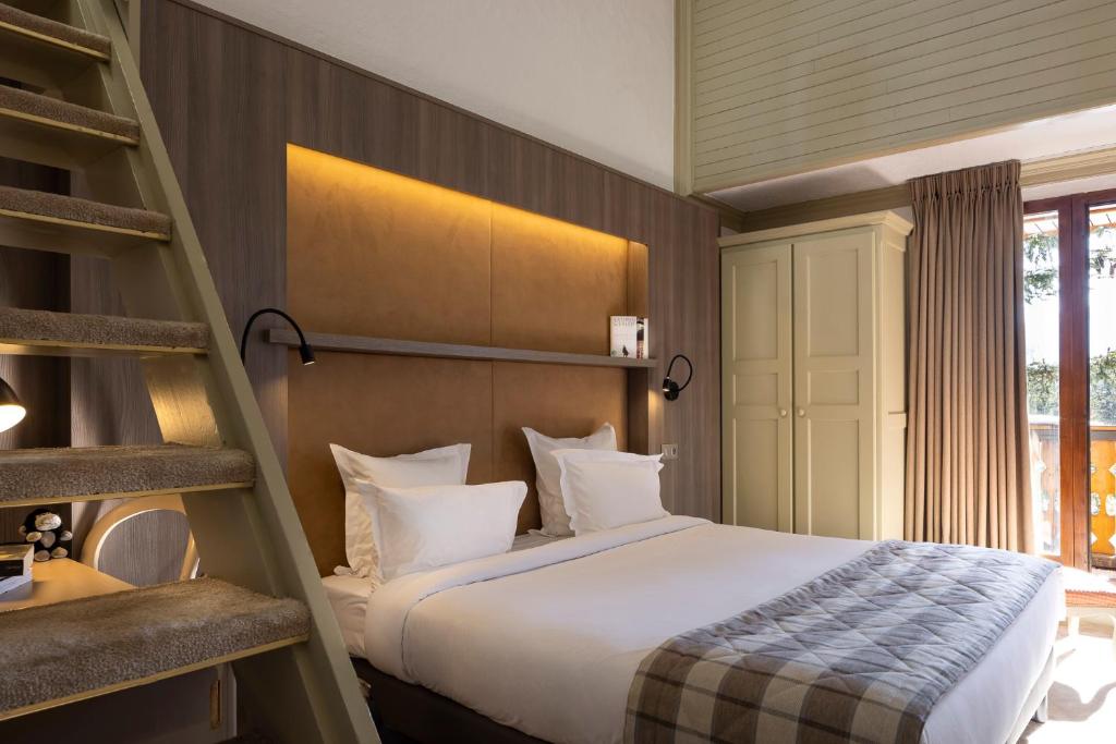 Postel nebo postele na pokoji v ubytování Hôtel Courcheneige