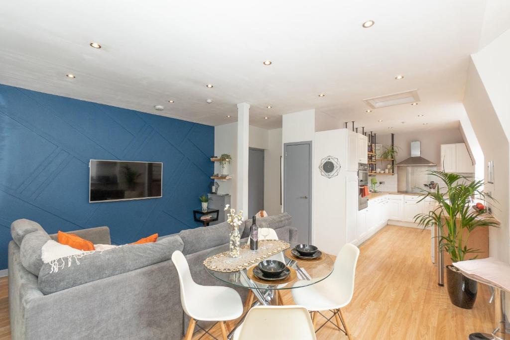 a living room with a couch and a table at Vibrant City Centre Living in Aberdeen