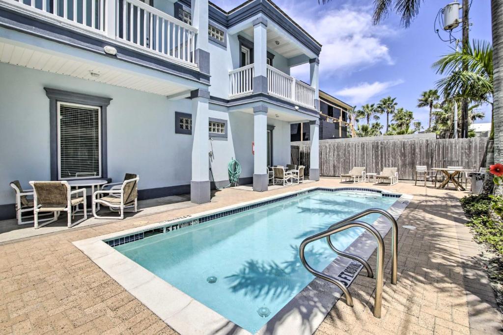 a swimming pool in front of a house at South Padre Island Condo - 200 Ft to Beach! in South Padre Island
