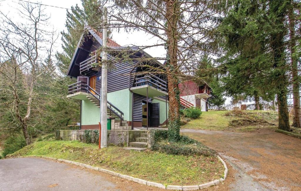 a house sitting on top of a hill next to a road at Holiday Home Bruno in Vrbovsko