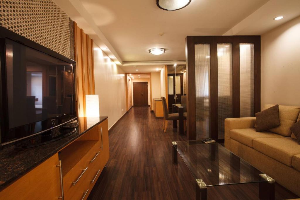 a living room with a couch and a television at 3C-Short-term rental allowed-2BRs Downtown Bangkok in Makkasan