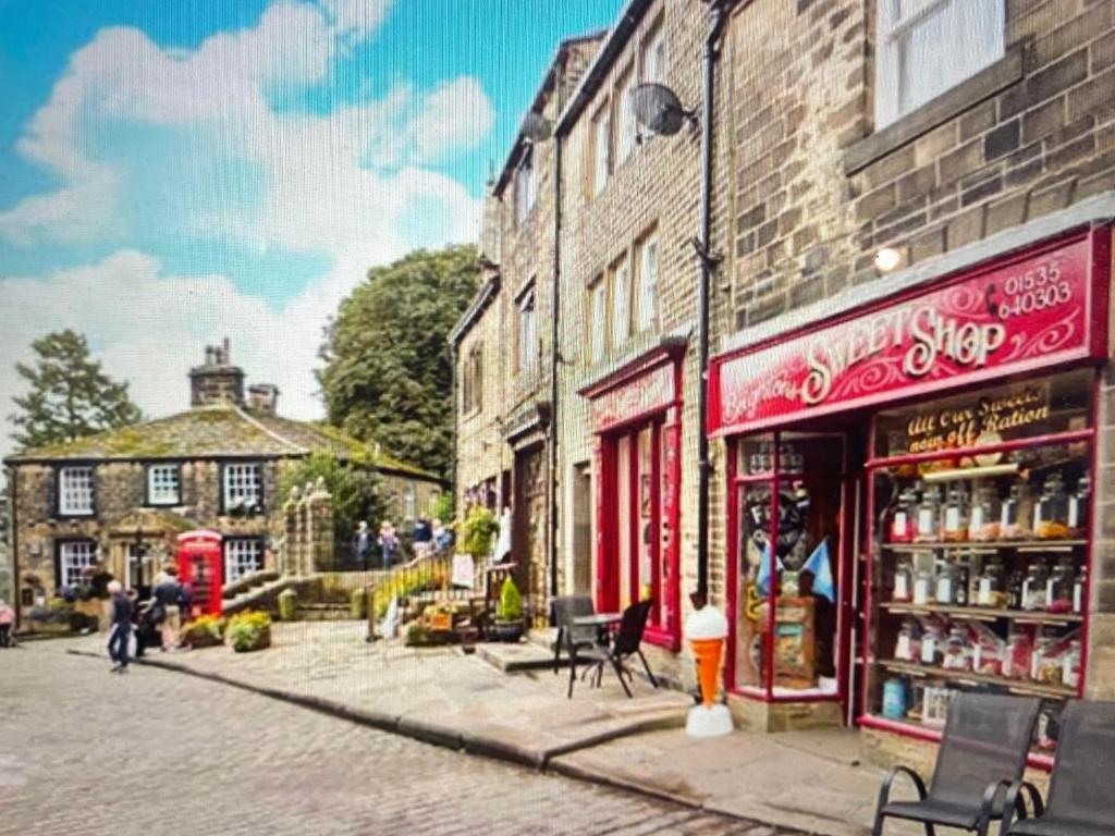 a city street with buildings and shops on a street at The Little Hideaway - Historic Gem off Haworth Main Street in Haworth