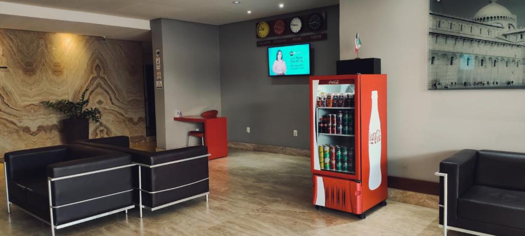a coca cola soda machine in a waiting room at Italian Palace Hotel in Parauapebas