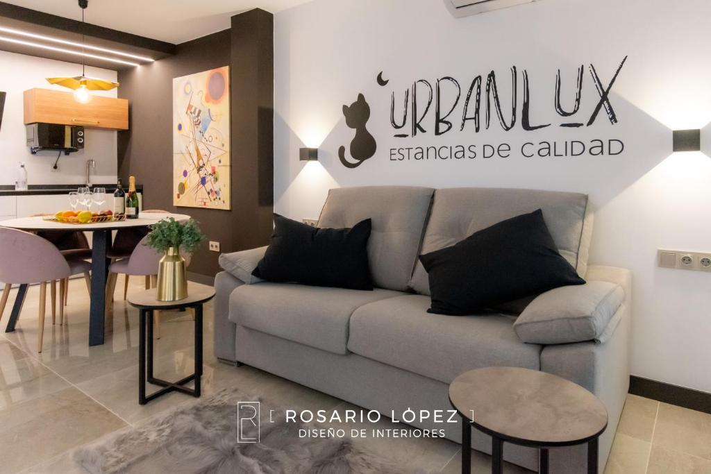 a living room with a couch and a table at Urbanlux Olimpia Superior in Albacete