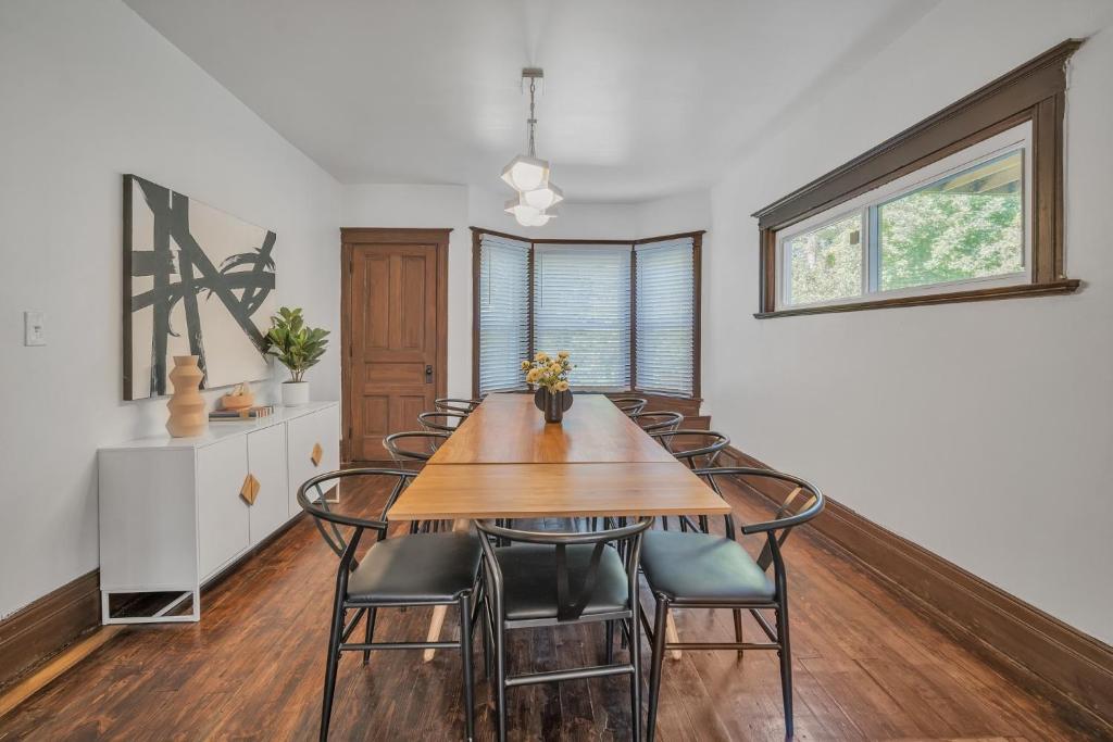 a dining room with a wooden table and chairs at Pet Friendly 5BR Home near Downtown Detroit in Detroit