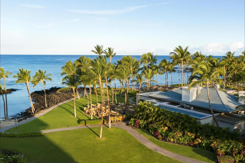 an aerial view of a resort with palm trees and the ocean at Fairmont Orchid in Waikoloa