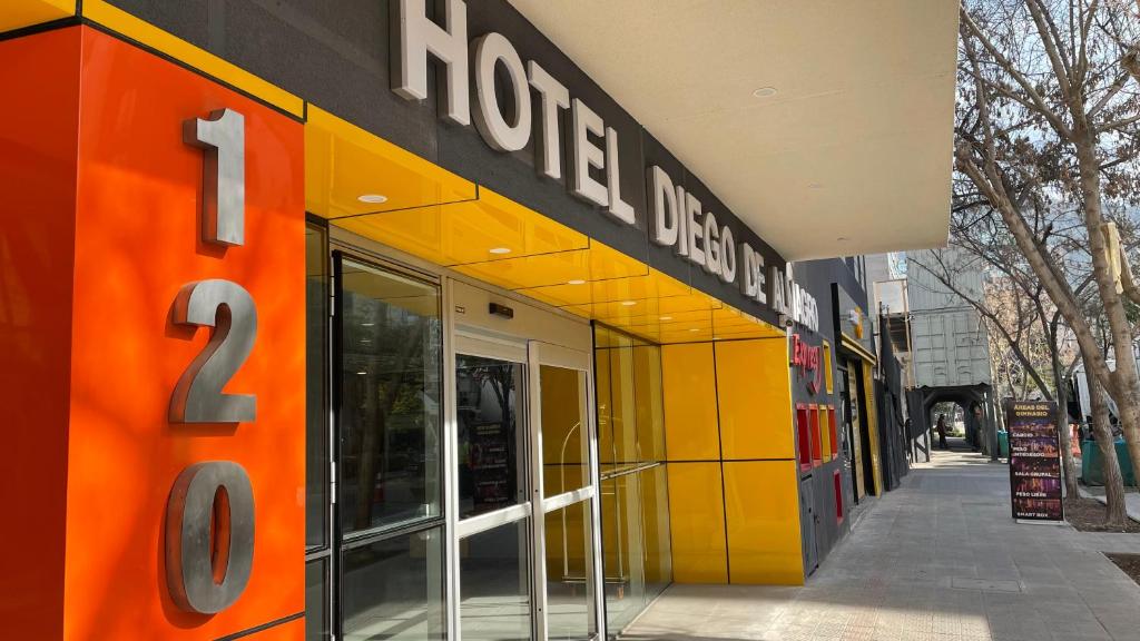 a store with an orange and yellow facade at Diego de Almagro Providencia Express in Santiago