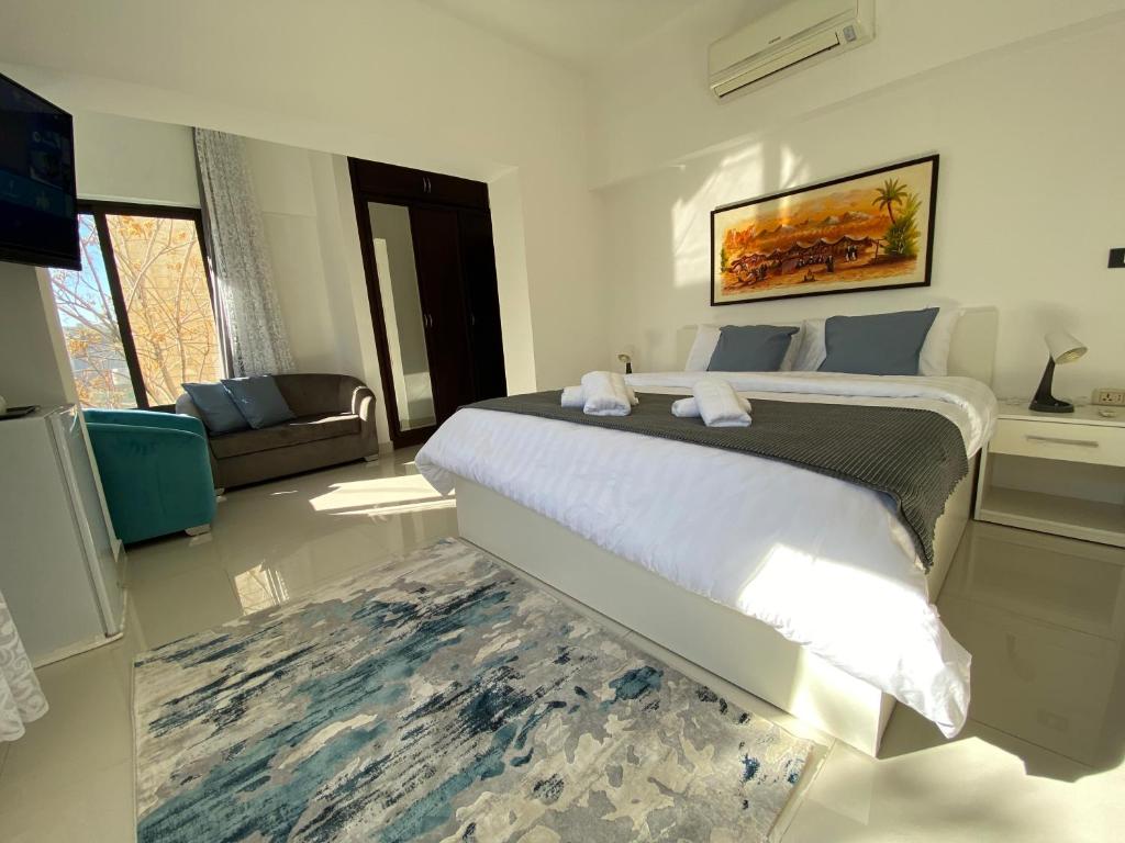 a bedroom with a large bed in a room at Lemon Tree Residence in Amman