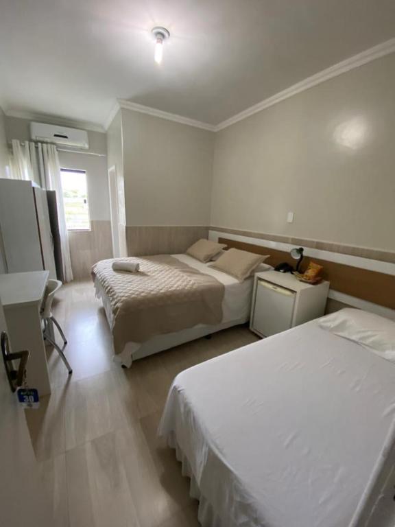 Postel nebo postele na pokoji v ubytování Faixa Hotel